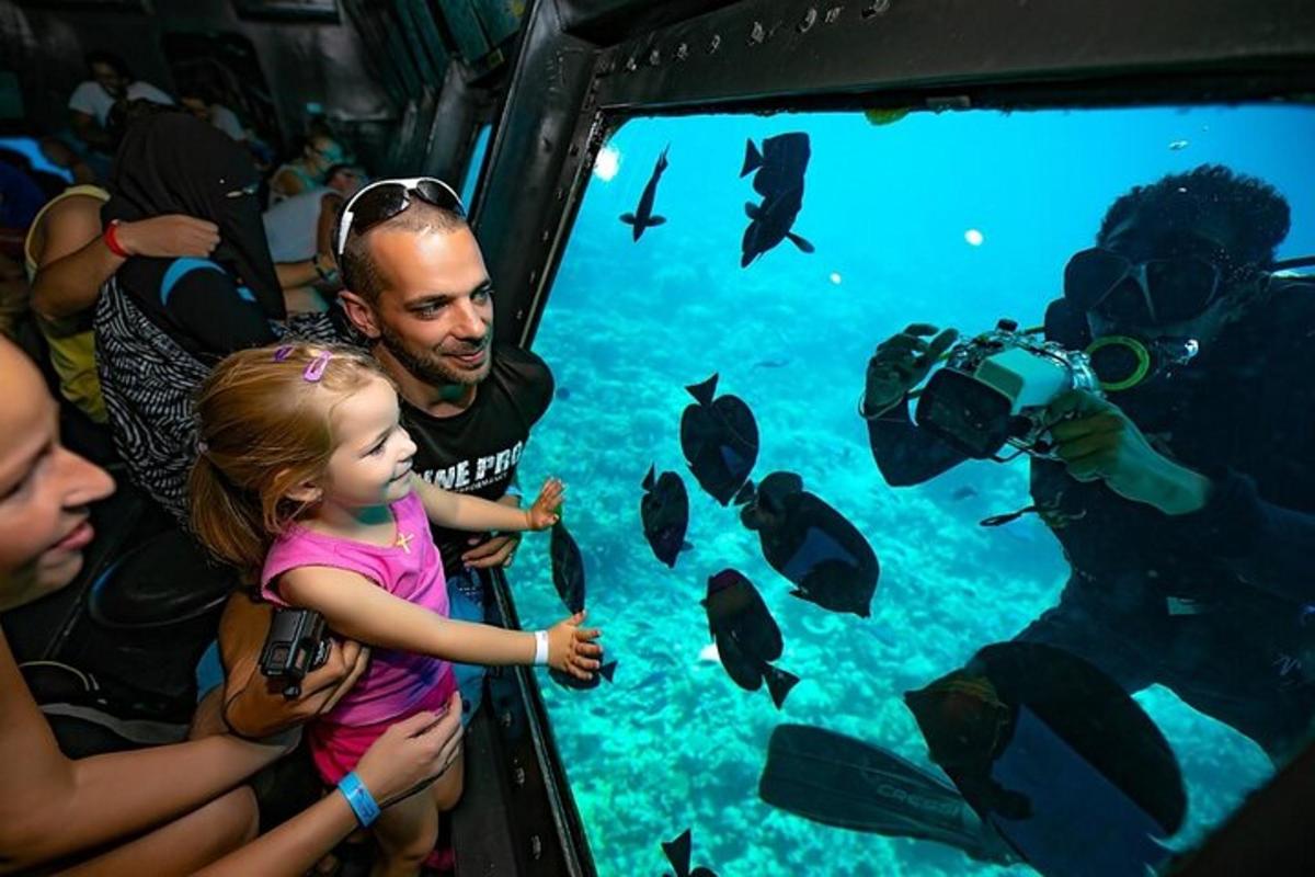 un uomo e una bambina guardano i pesci in un acquario