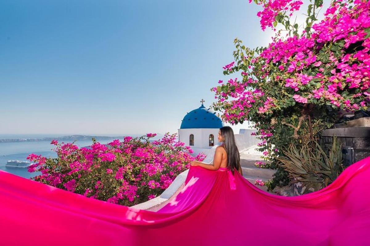 a woman in a pink dress sitting in flowers