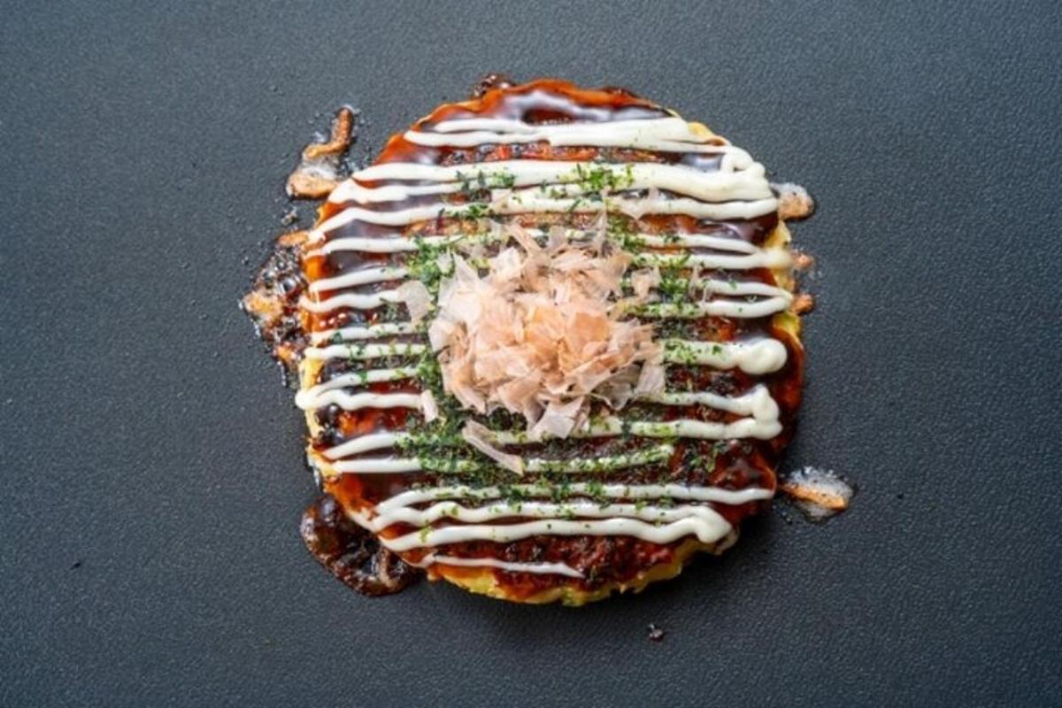 a sandwich with white sauce on it on a table