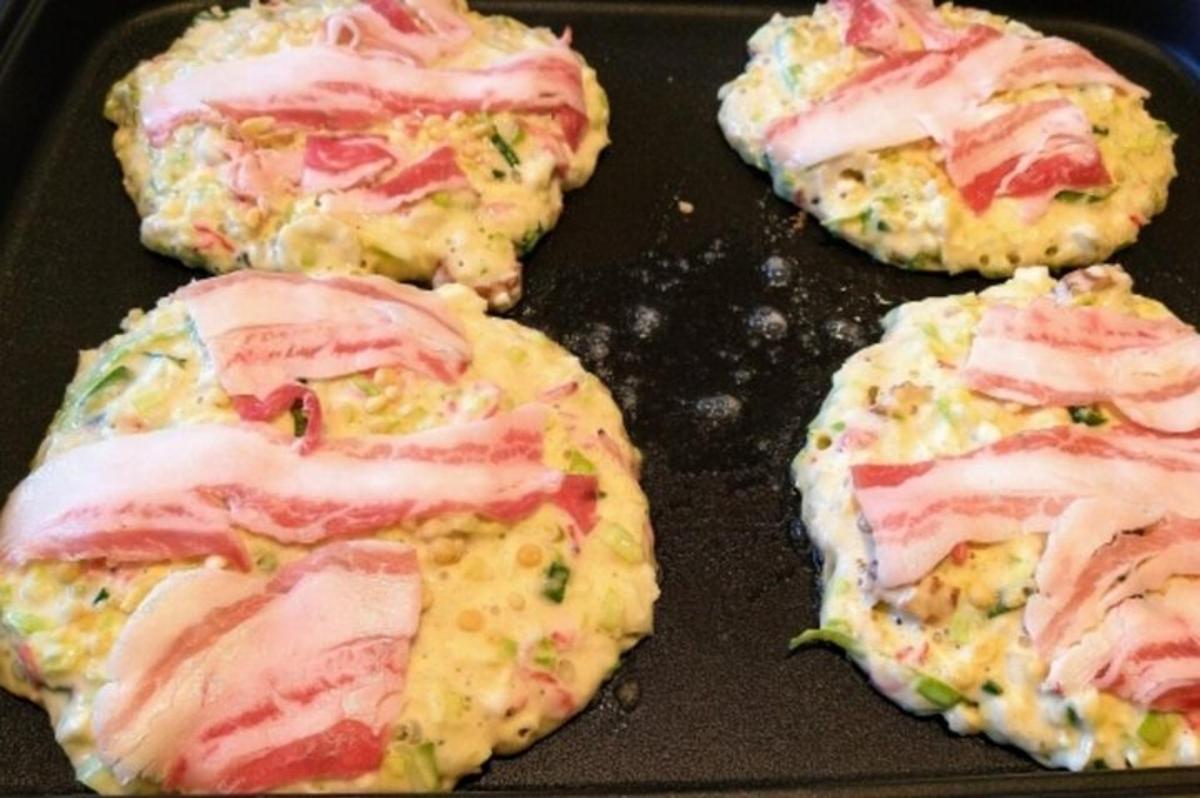four pastries with ham and cheese in a pan
