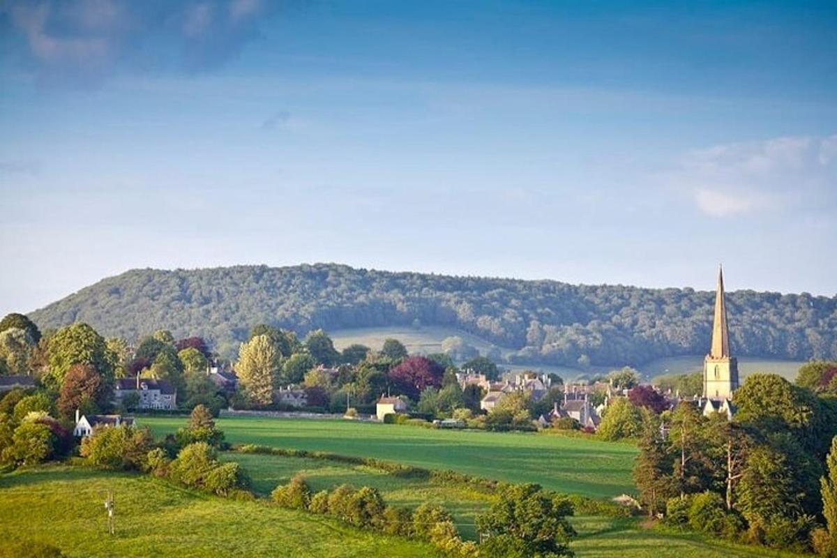 a small town with a church and a green field