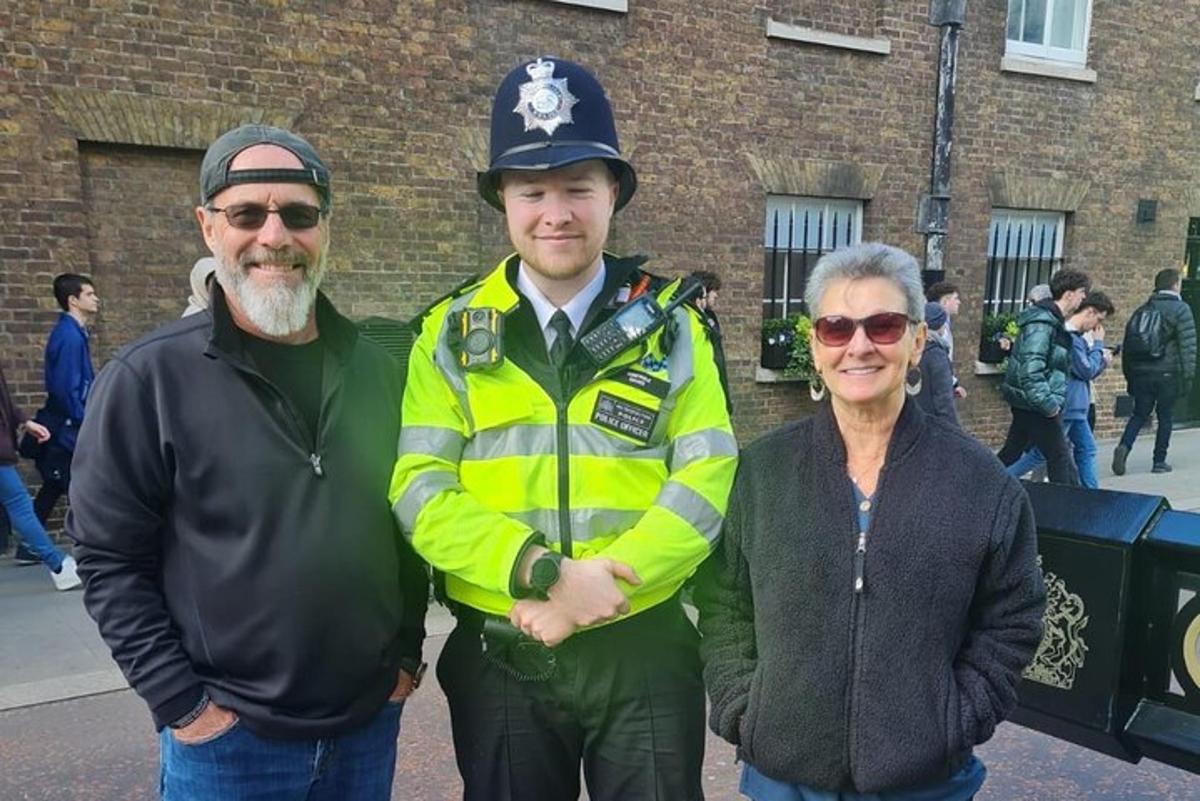 dos homes i una dona al costat d'un agent de policia