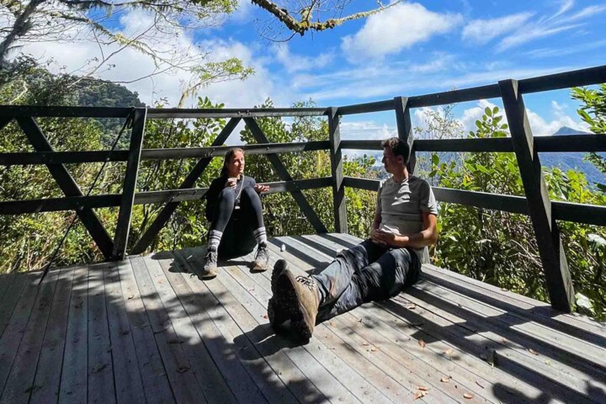 two men are sitting on a wooden deck