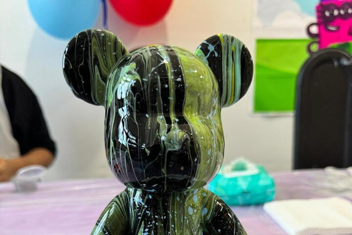 a green glass bear sitting on top of a table
