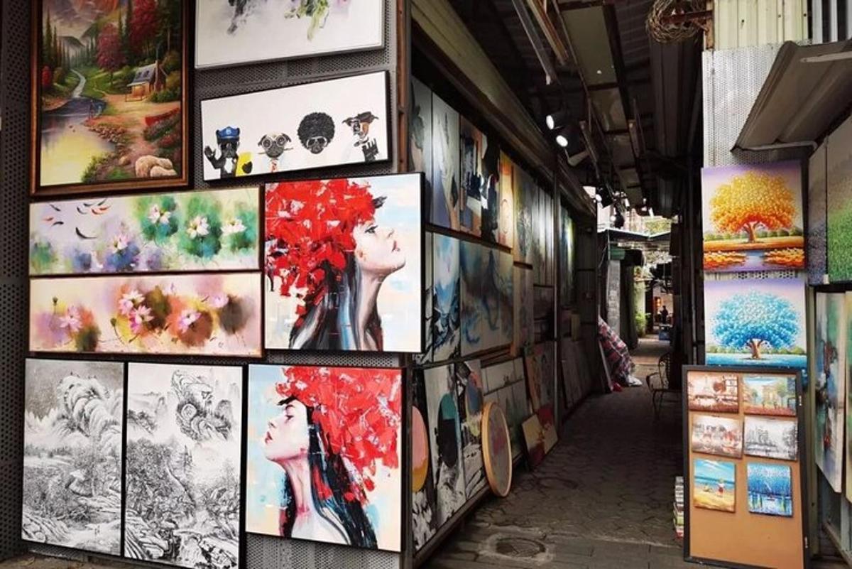 a wall full of art on the side of a building