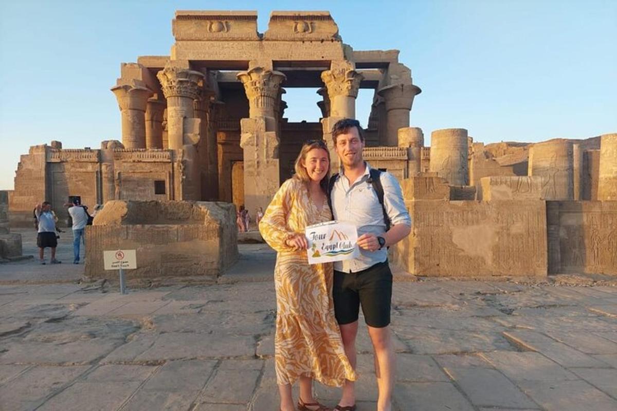 a man and a woman standing in front of a building