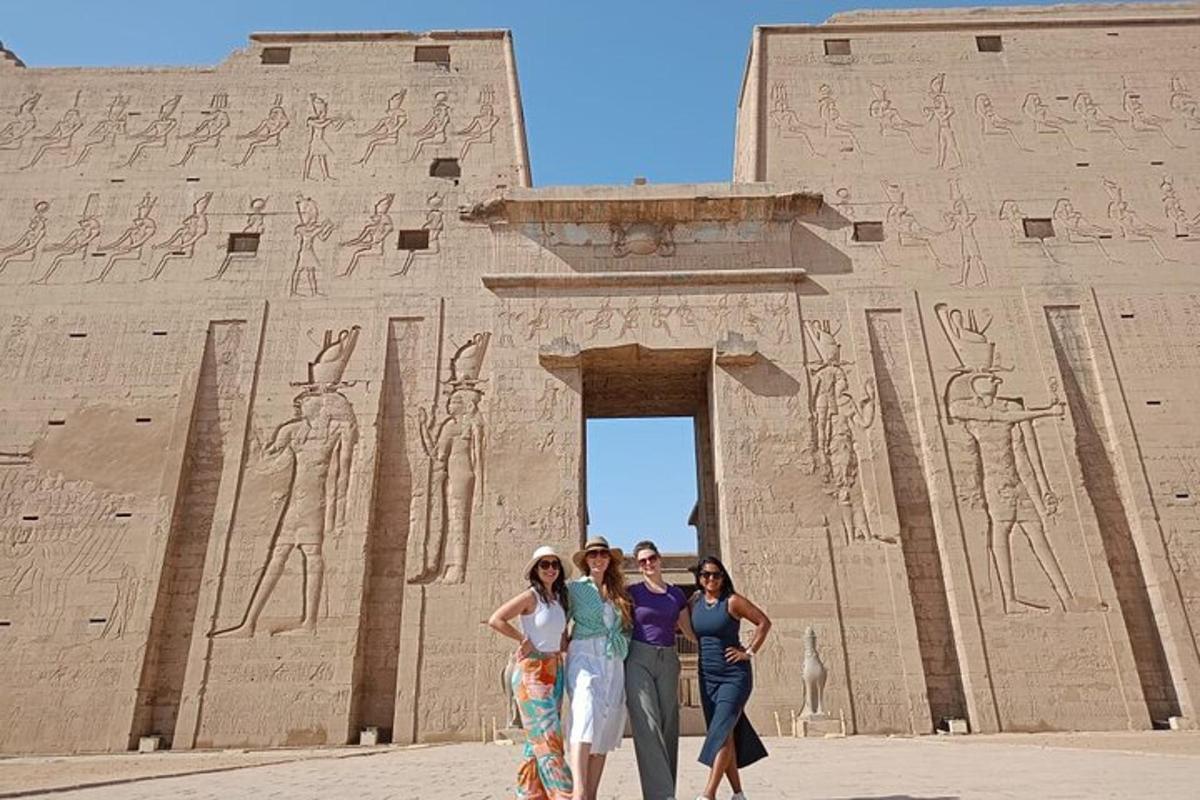 three women standing in front of an ancient building