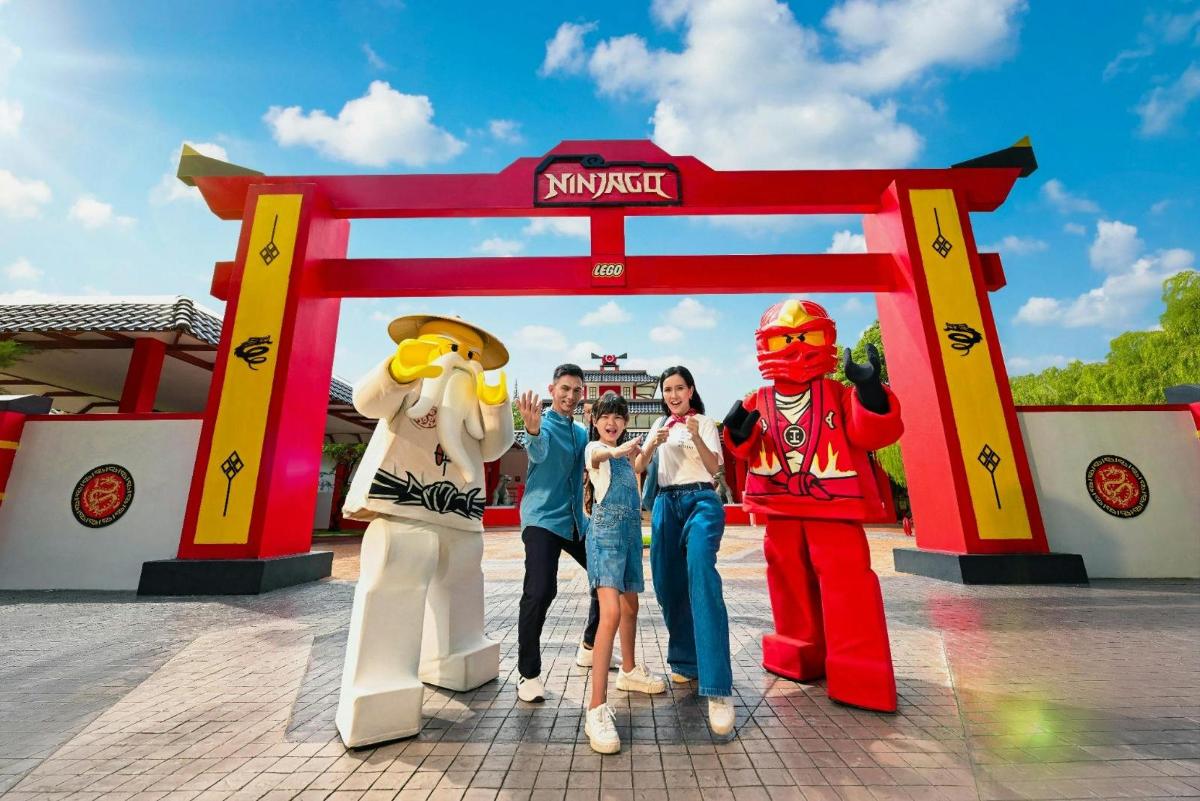 a group of people standing in front of a play structure