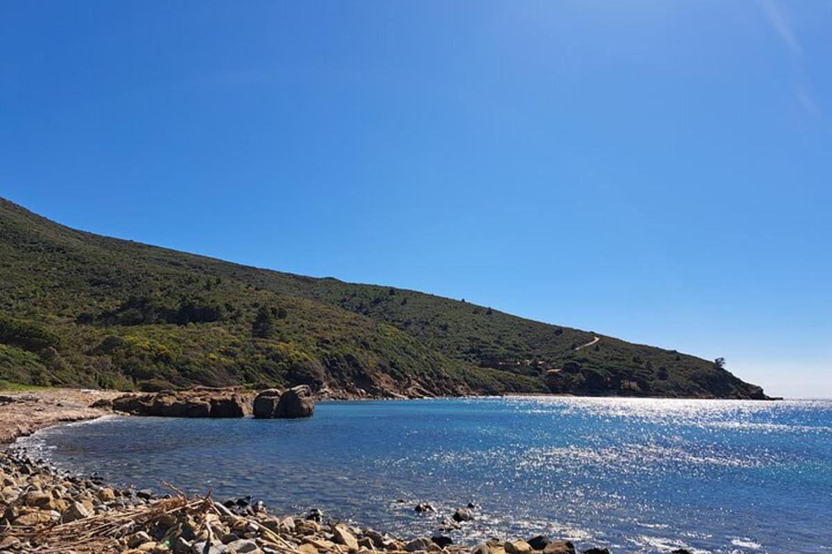 a large body of water next to a mountain