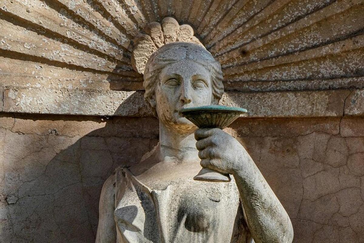 a statue holding a bowl in his hand