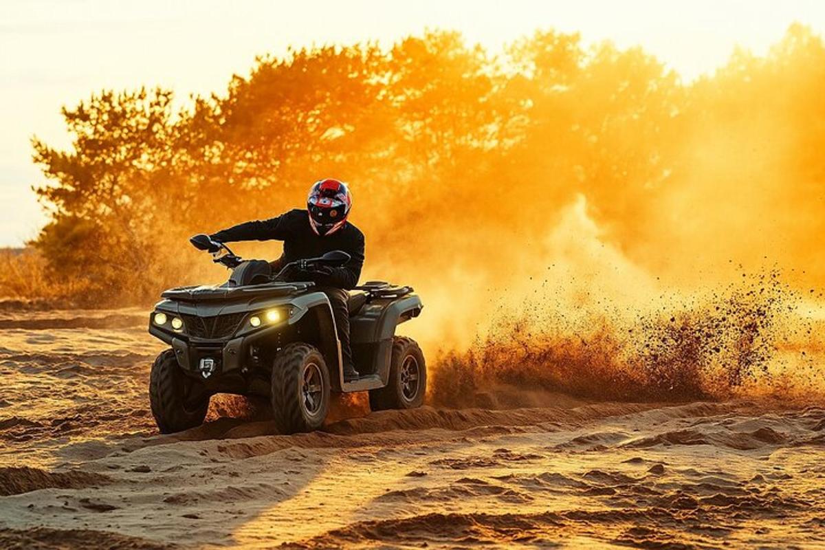 a man riding a quad bike in the sand
