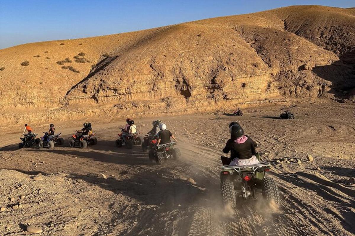 a group of people riding motorcycles on a dirt road