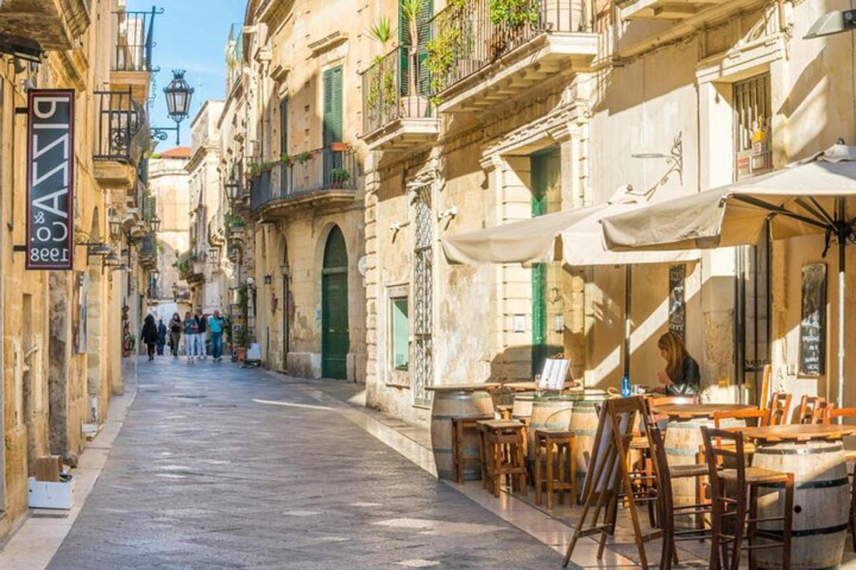 an empty street with tables and chairs and buildings