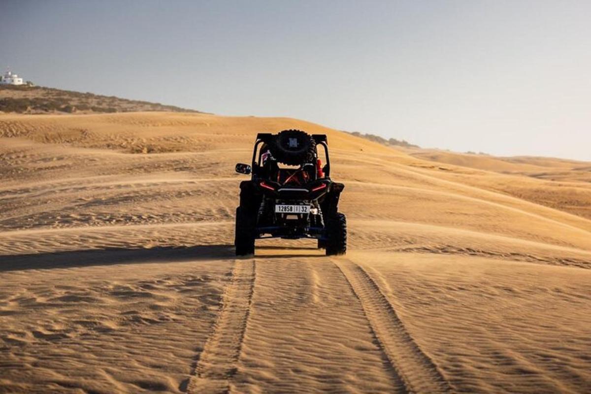 a person riding a quad bike in the desert
