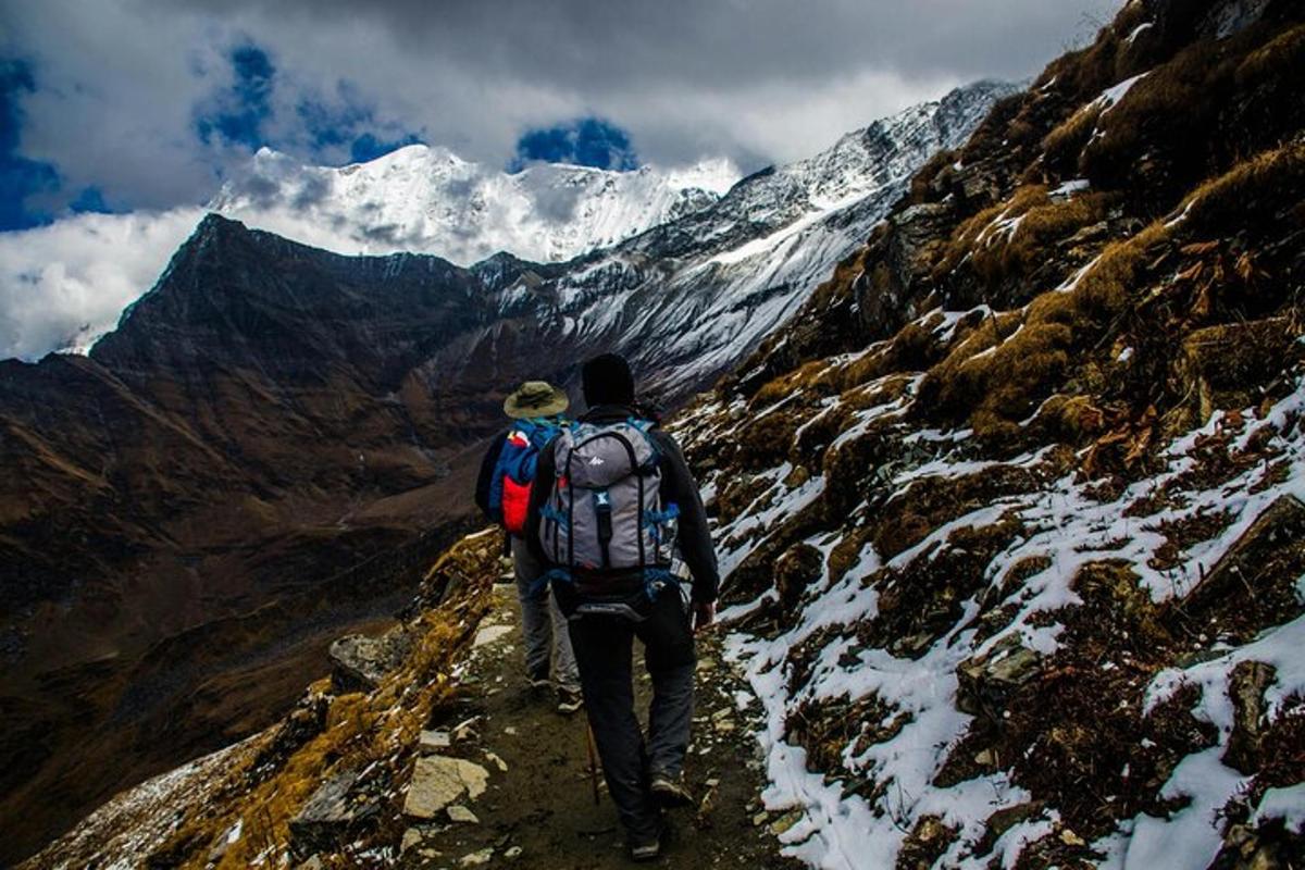 a man with a backpack walking up a mountain