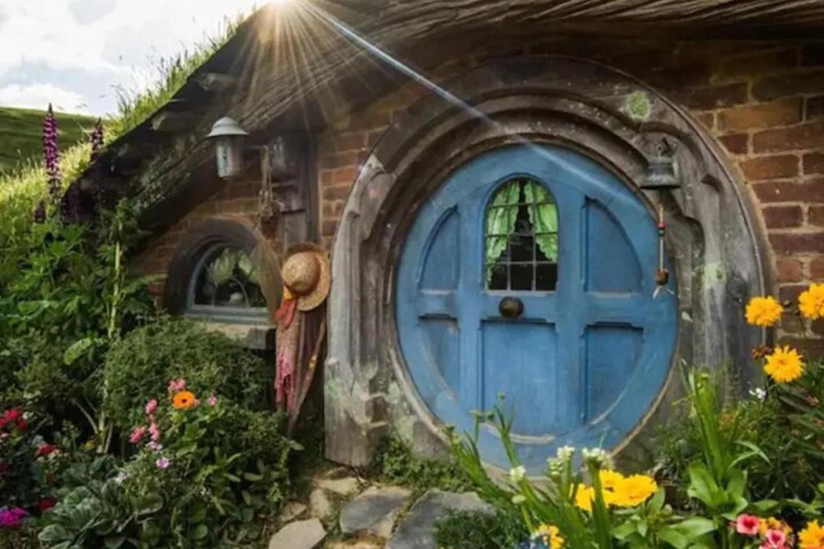 a blue door in a brick house with flowers