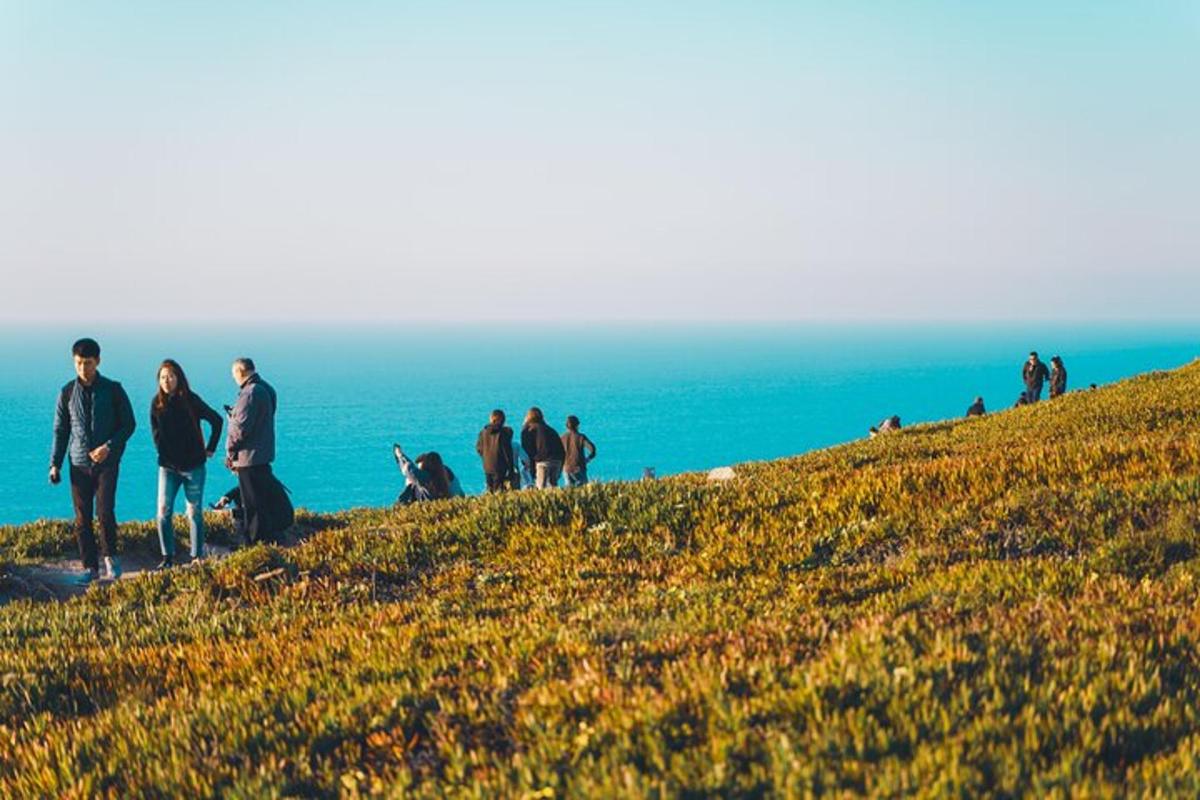 a group of people standing on top of a hill