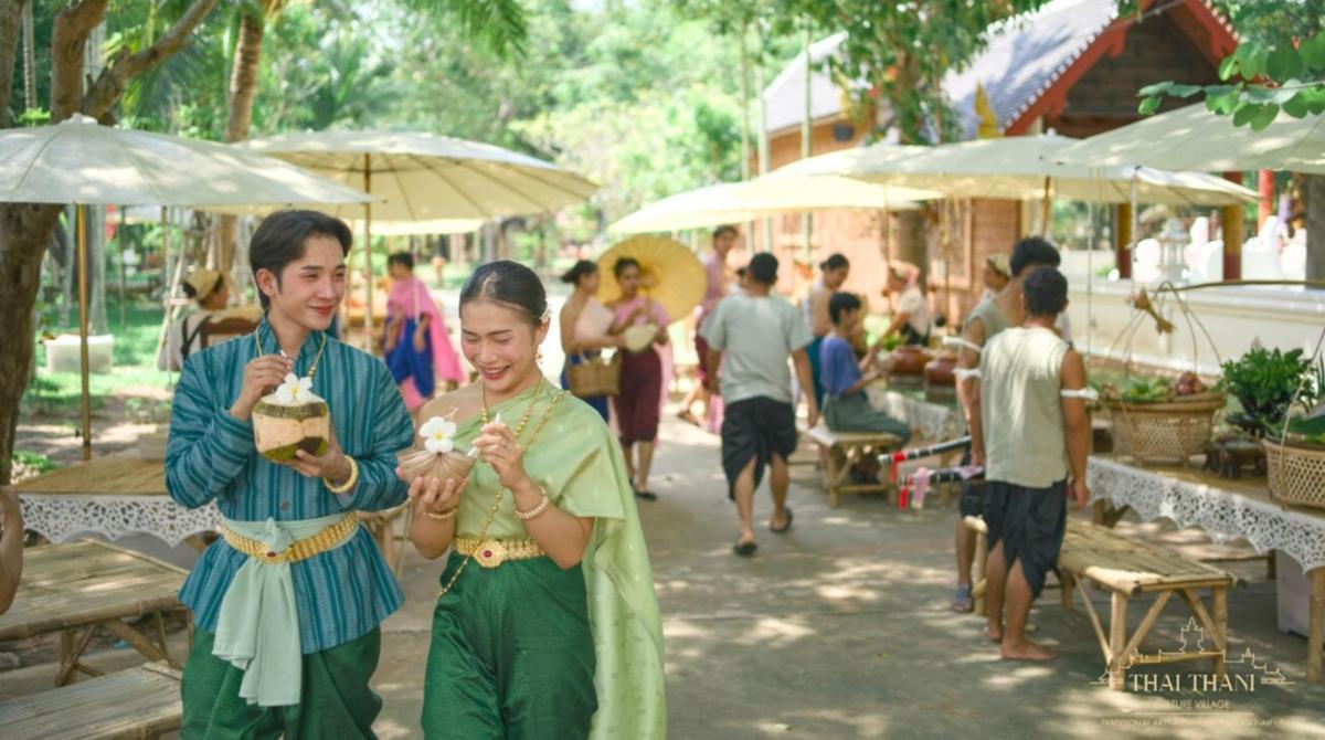 a couple of people standing next to each other eating food