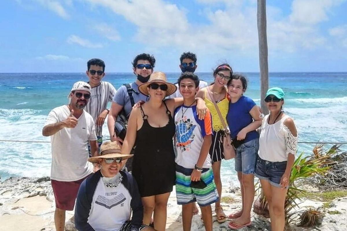 a group of people posing for a picture on the beach