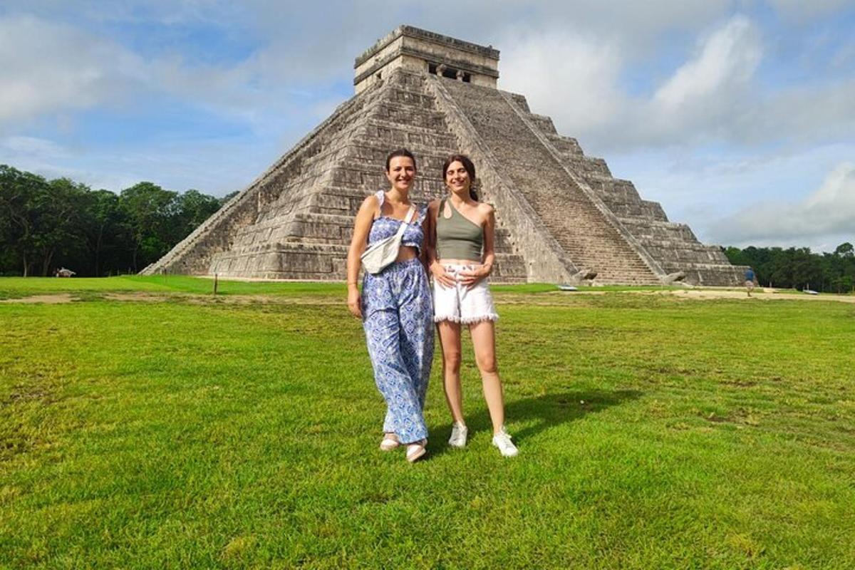 a man and a woman standing in front of a pyramid