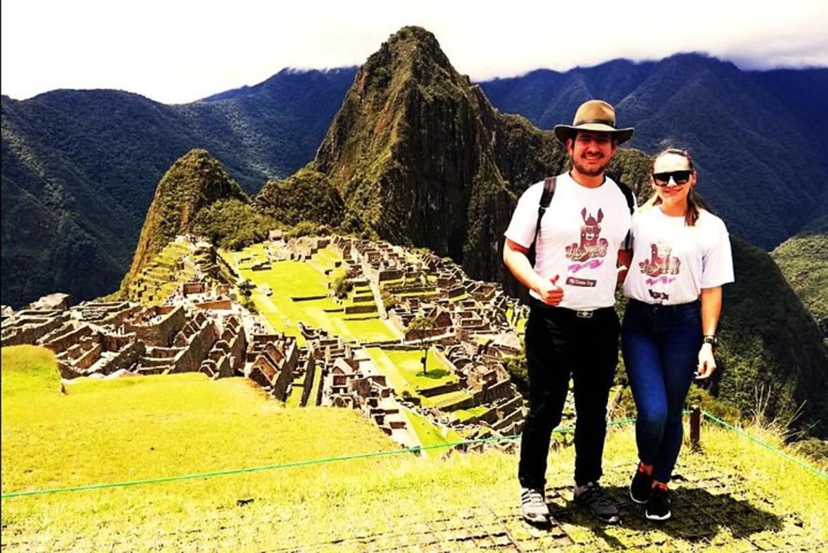 un uomo e una donna in piedi sulla cima di una montagna