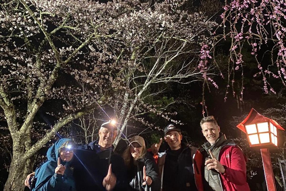 a group of people posing for a picture at night