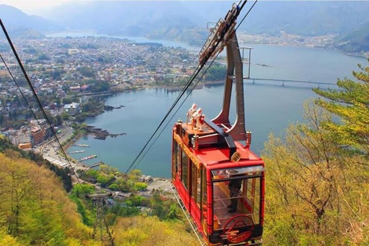 eine rote Seilbahn, die einen Berg hinauffährt
