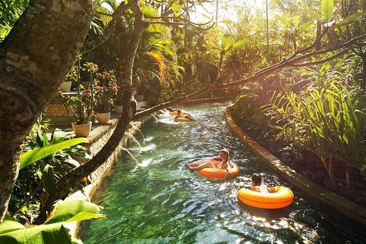 two people tubing down a river in a jungle