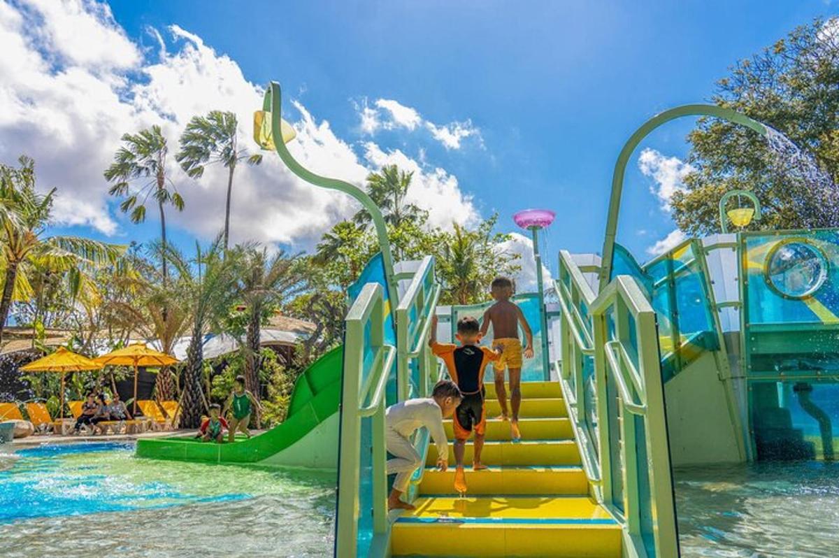 a group of kids on a slide at a water park