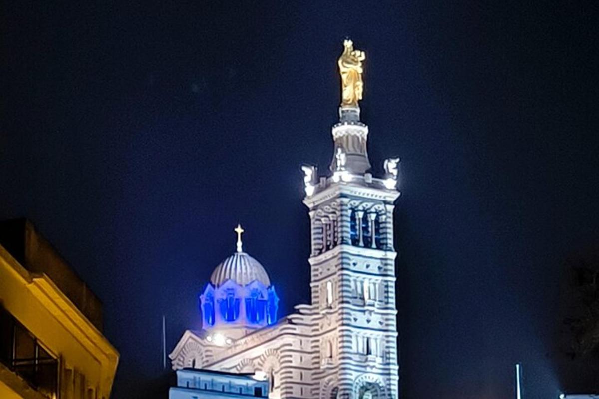 a tall building with a statue on top of it