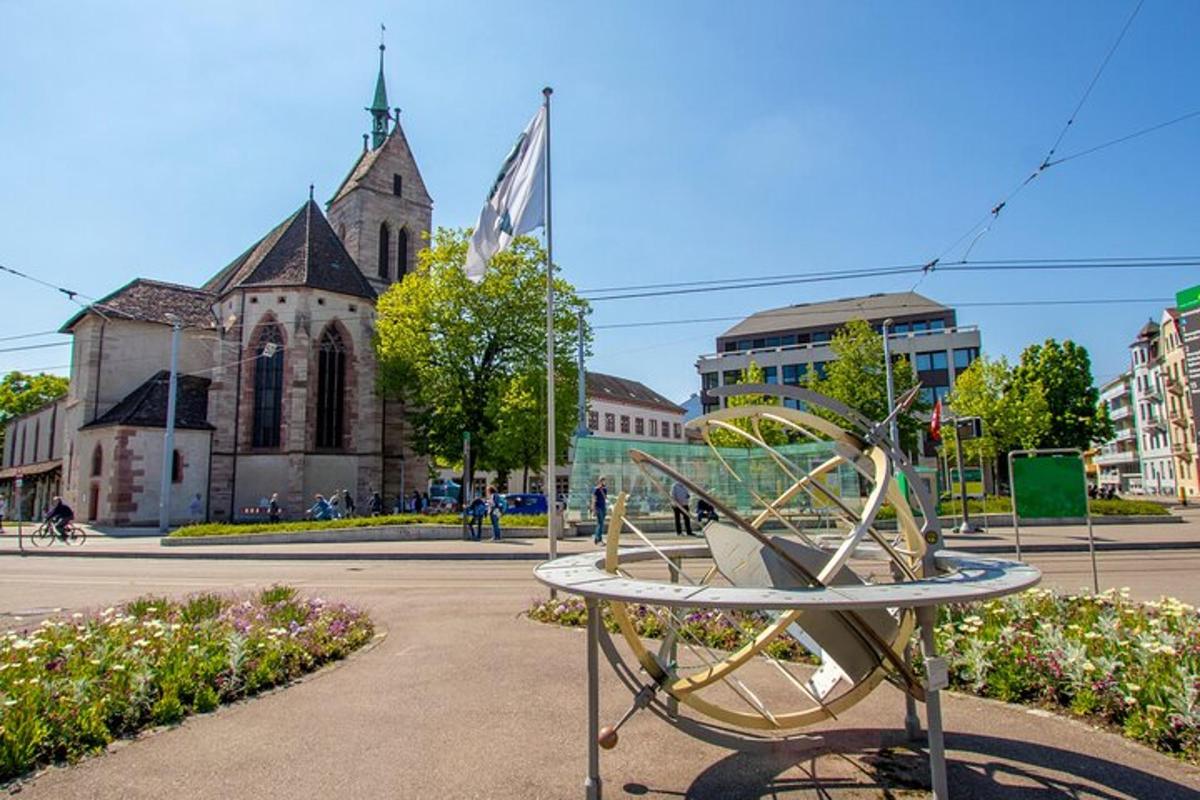 a sculpture in front of a building with a church