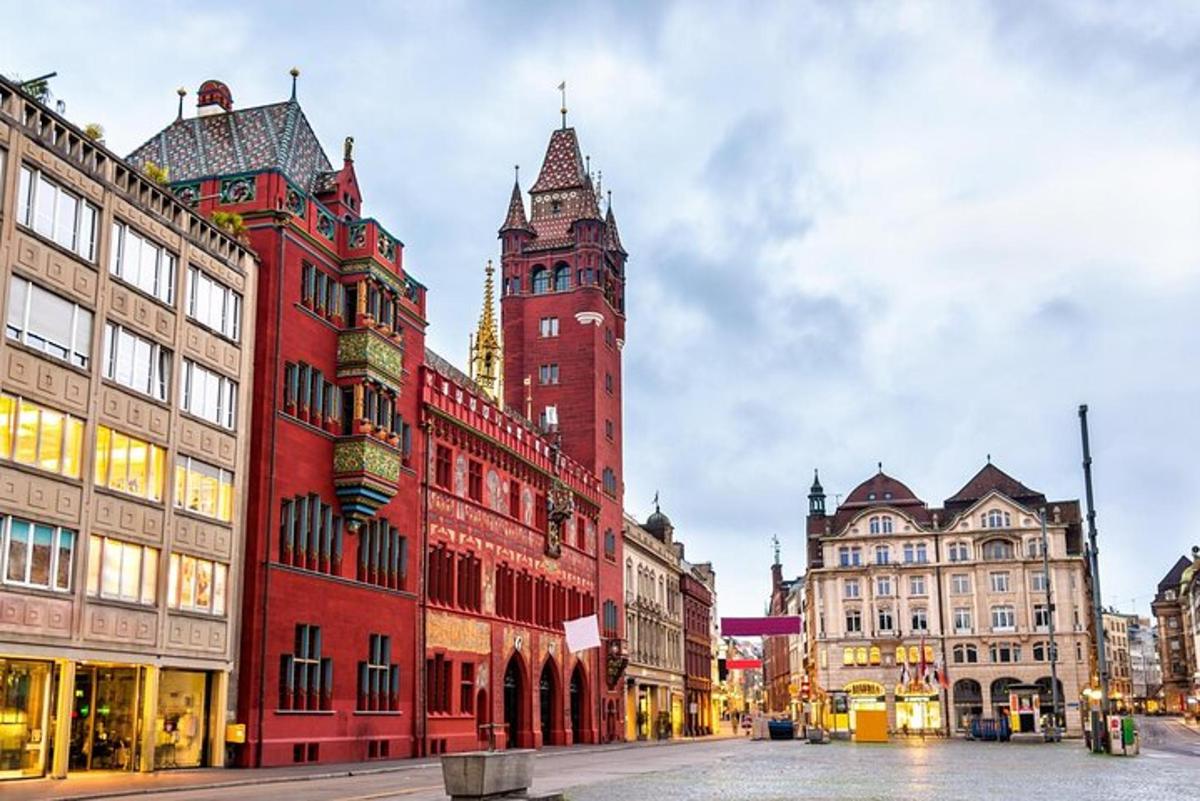 a large red building with a clock tower on a street