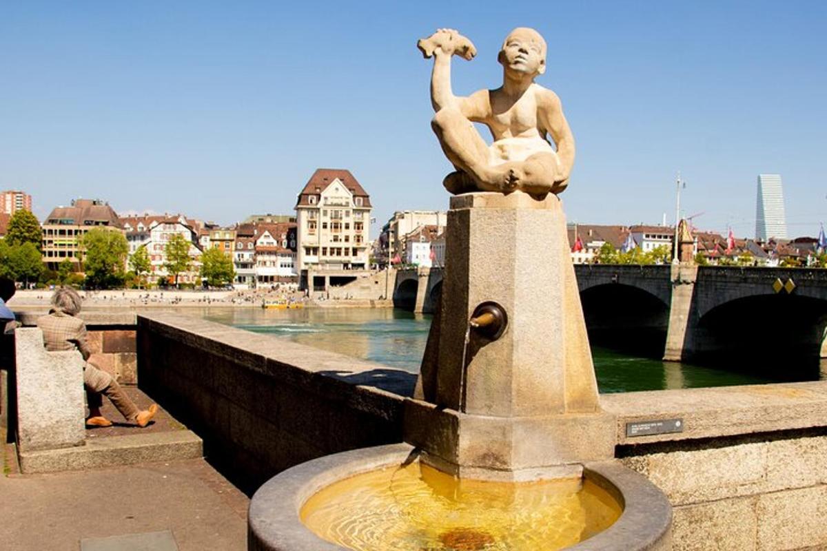 a statue of a man sitting on top of a fountain