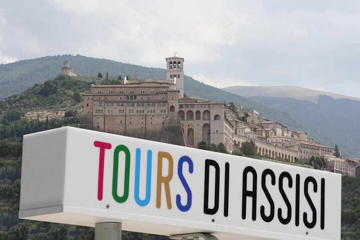 a sign in front of a large building on a hill