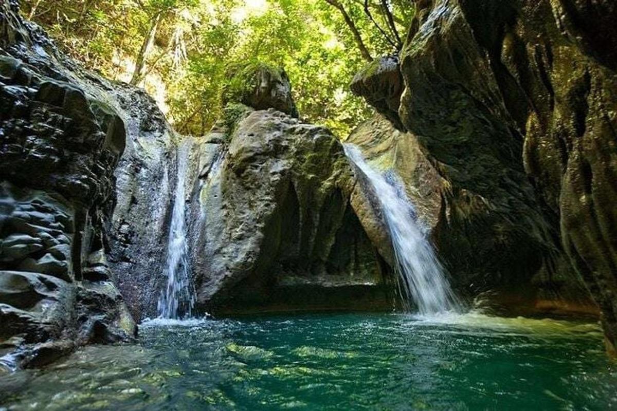 a waterfall in the middle of a pool of water