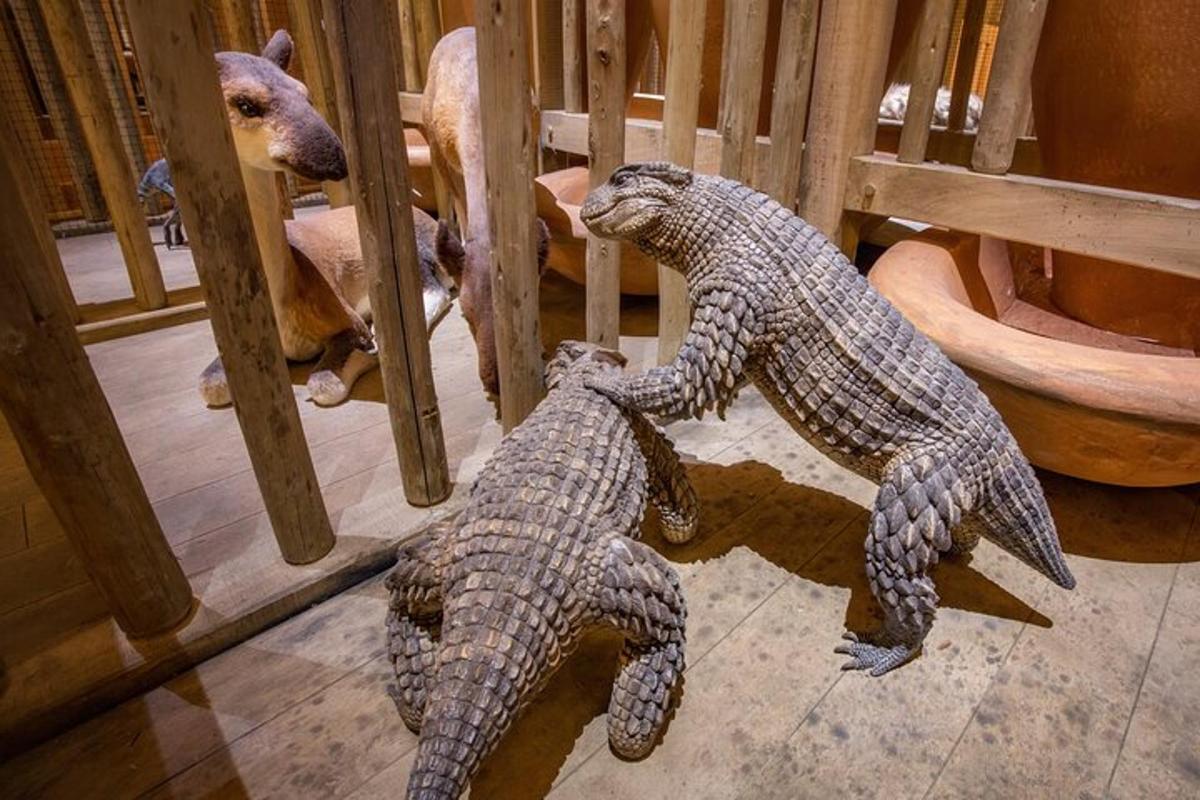 two stuffed animals are leaning against a fence