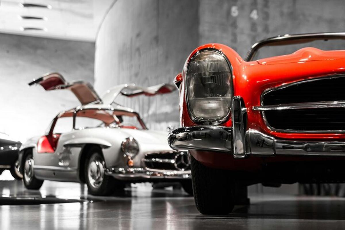 two vintage cars are parked in a garage