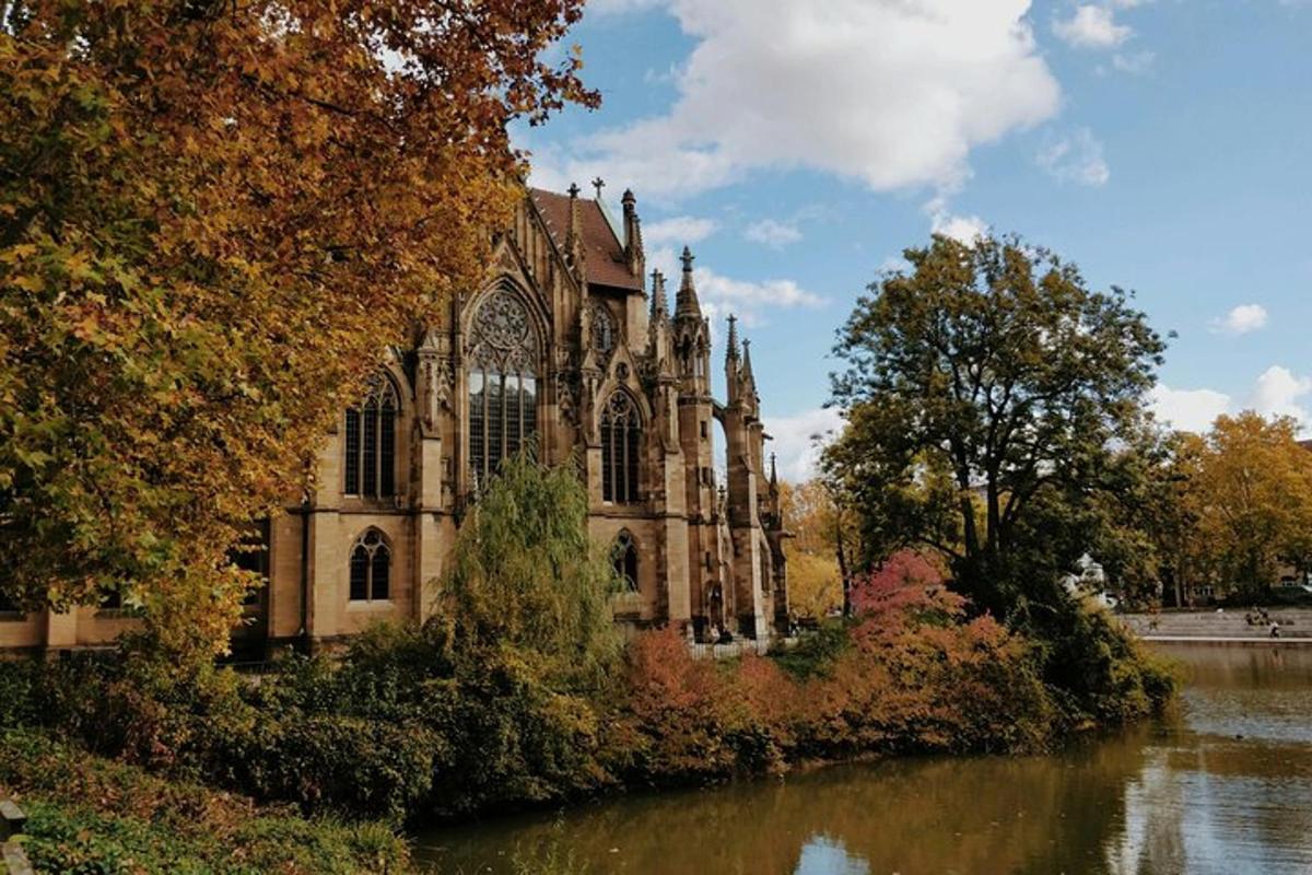 an old church next to a body of water