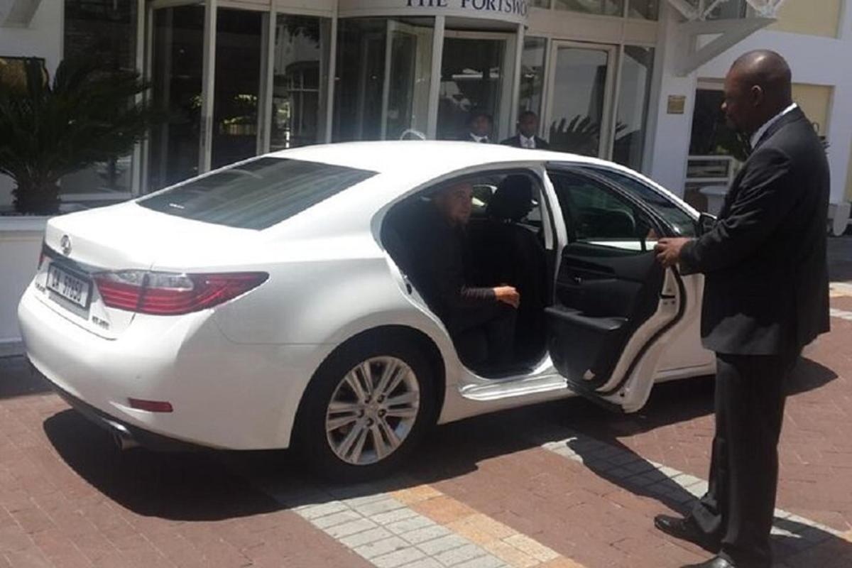 a man opening the door of a white car