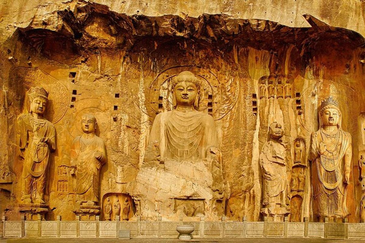 a large stone wall with a statue on it