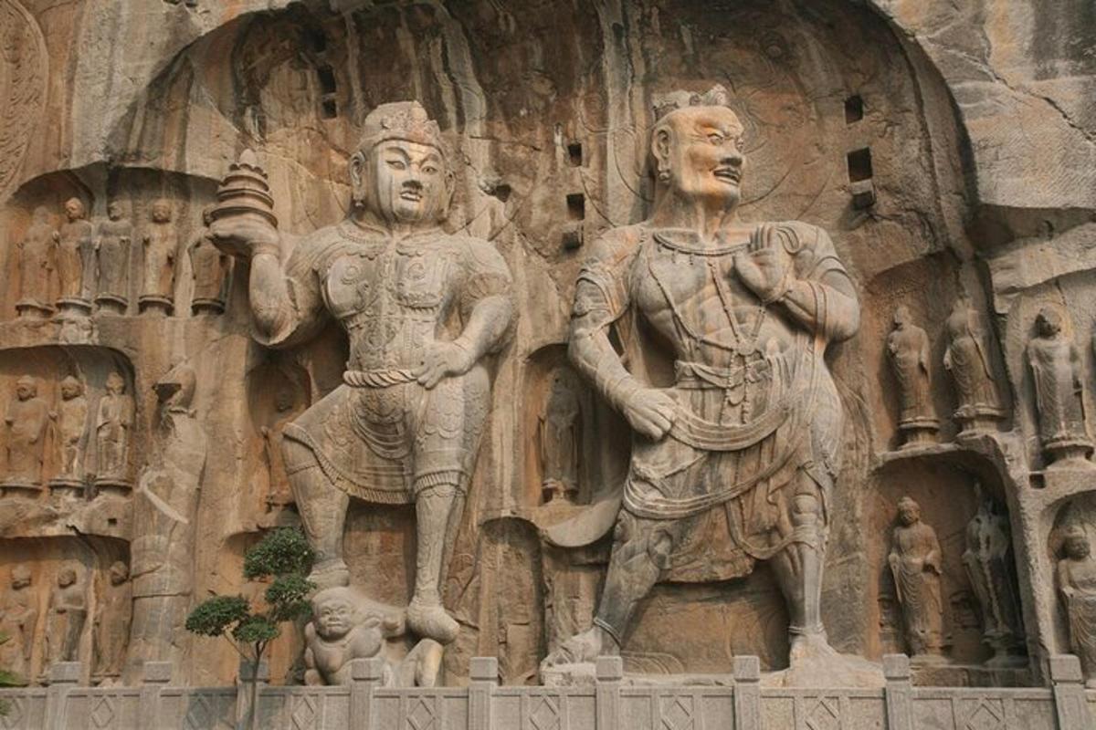 a stone sculpture of two men on the side of a building