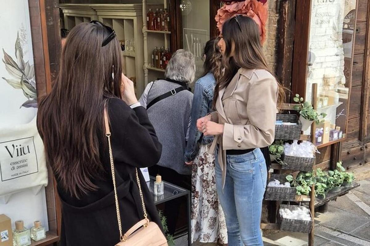 two women are looking in a store window