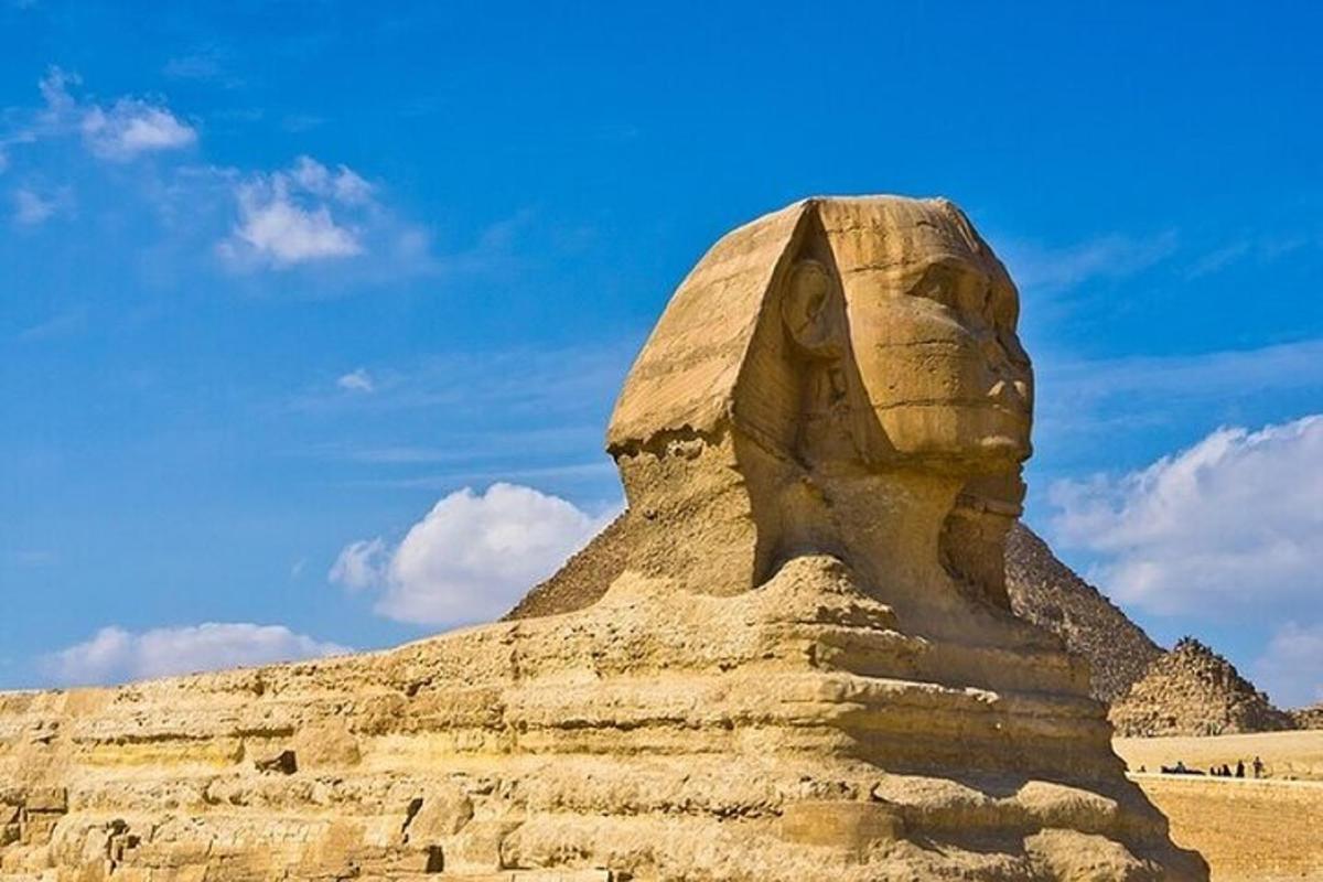 una estatua frente a una pirámide