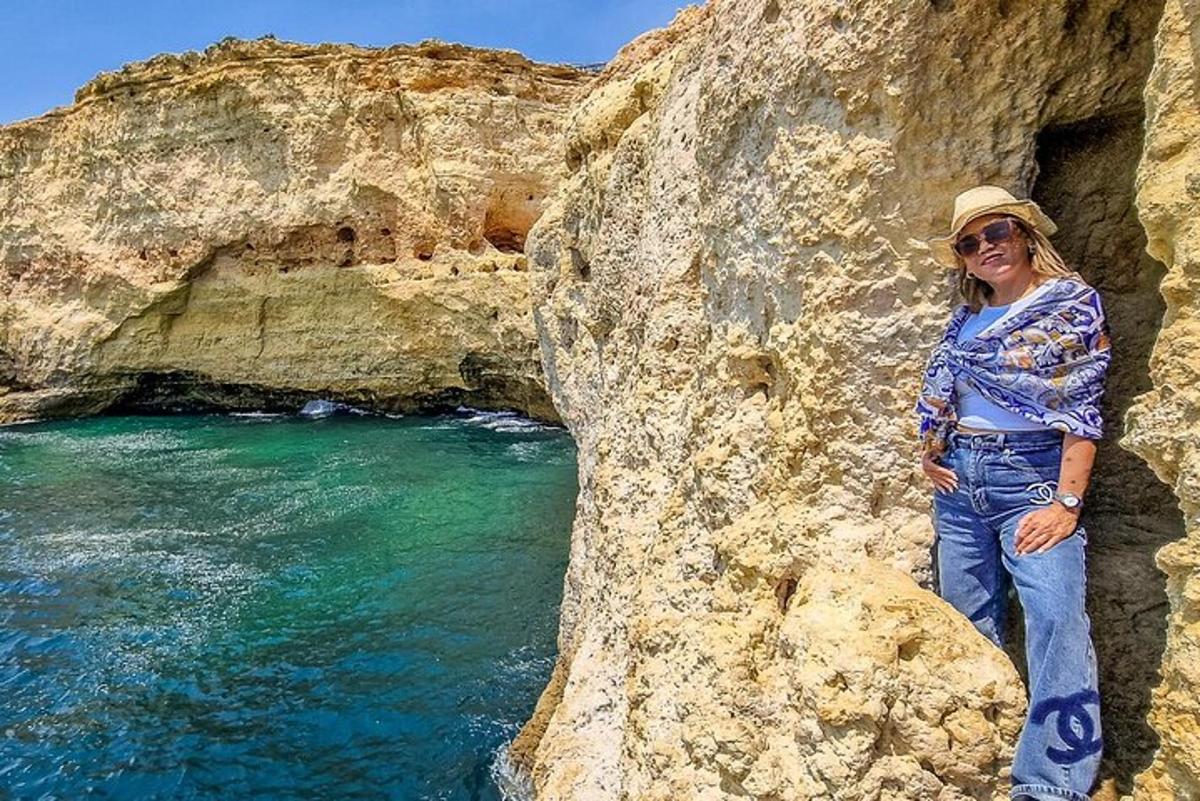 a woman standing on a rock next to the ocean