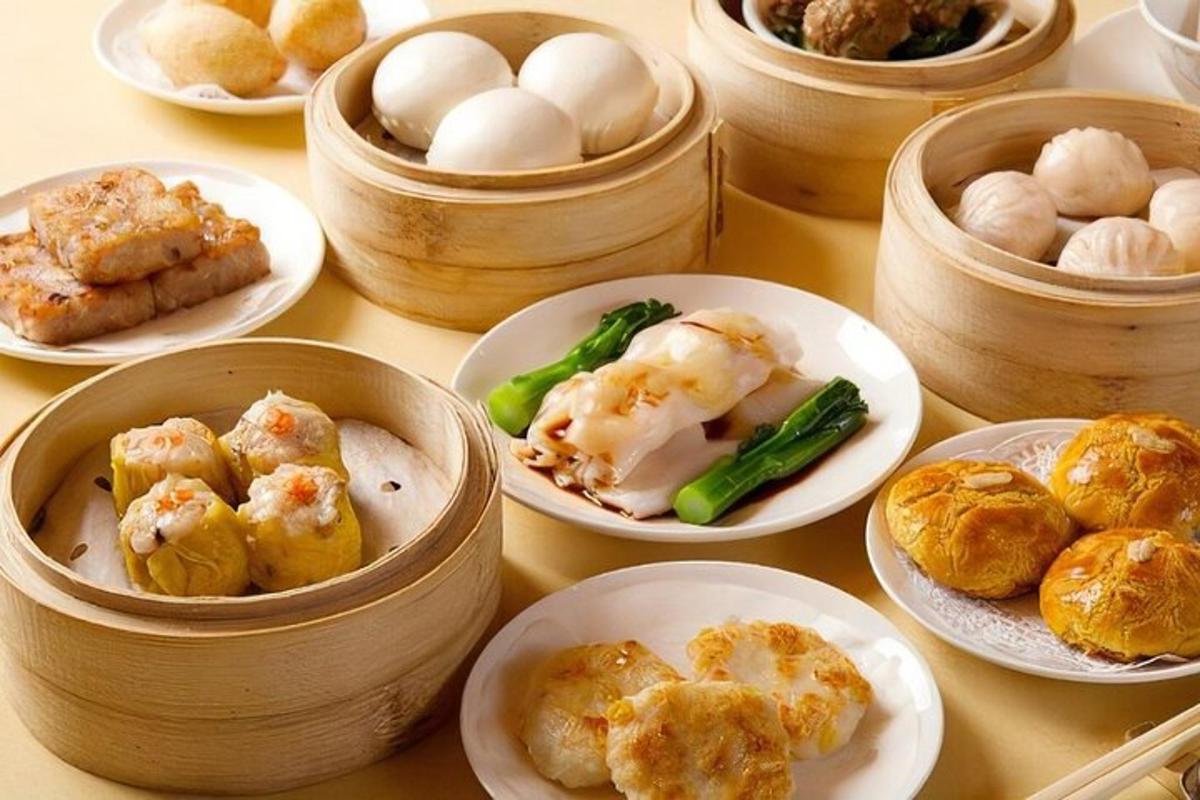 a table topped with plates of food in wooden containers