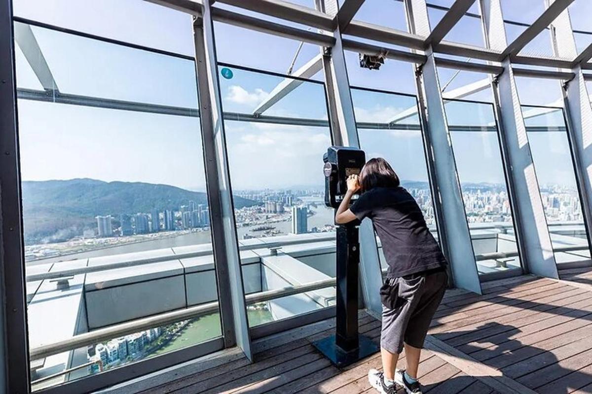a woman taking a picture of the view from a building