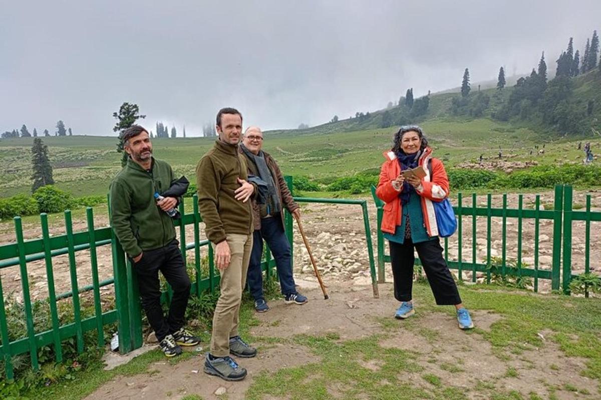 a group of people standing next to a fence