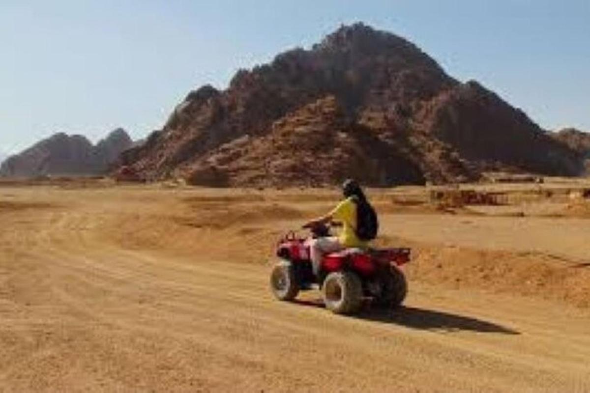 a person riding a quad bike in the desert