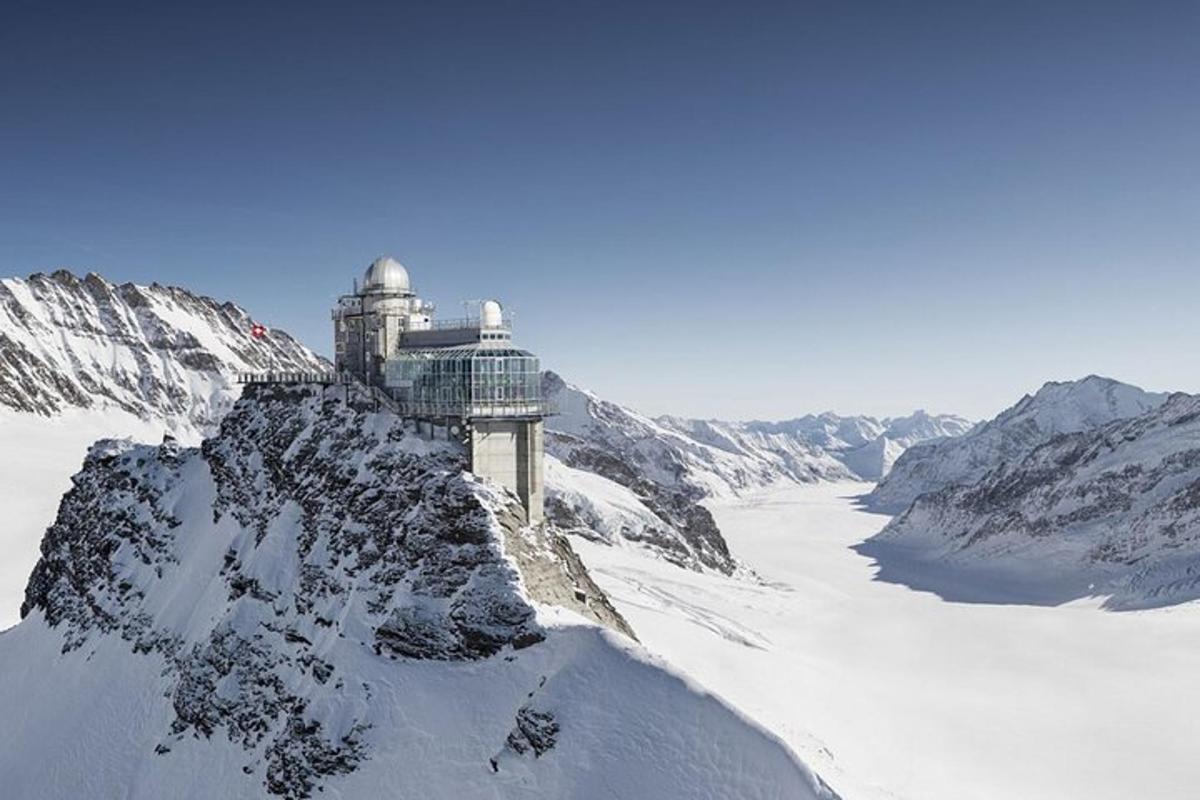 a snow covered mountain with a building on top of it