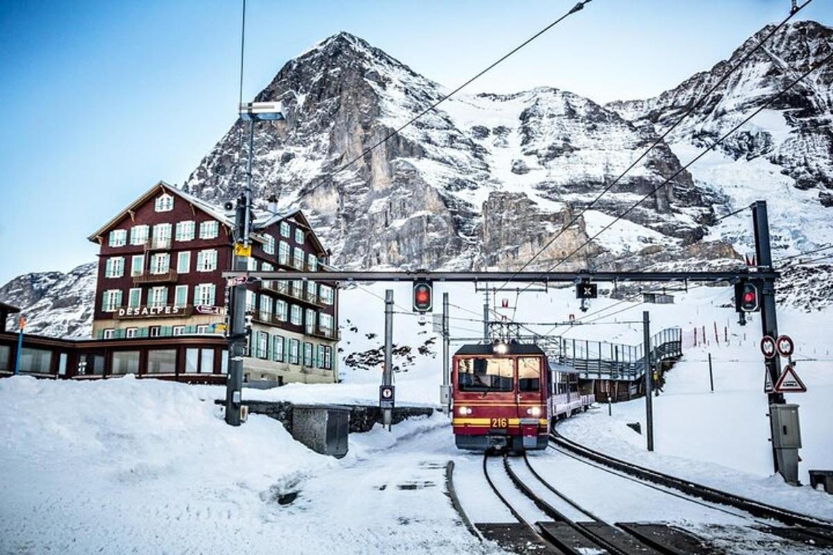 a train on the tracks in front of a mountain